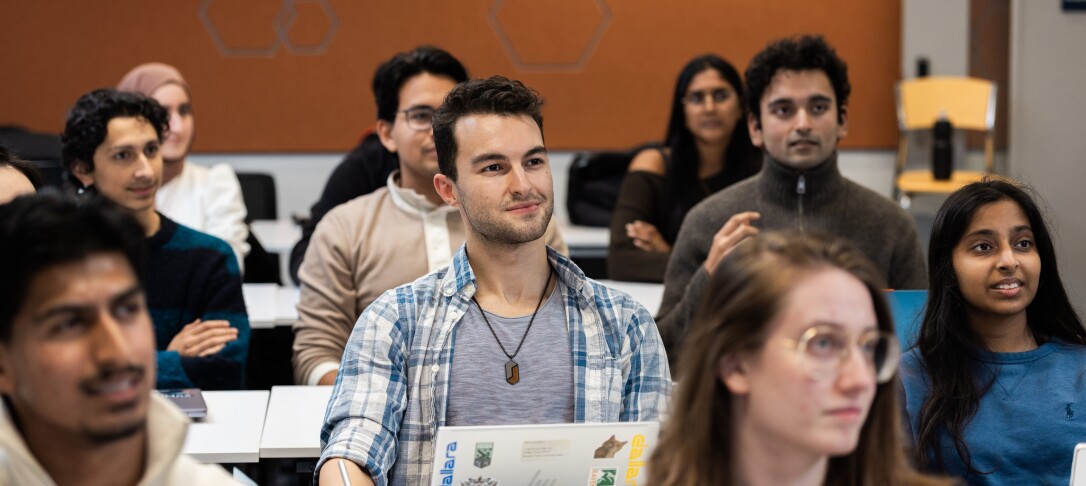 Students facing forward  in rows in a classroom 