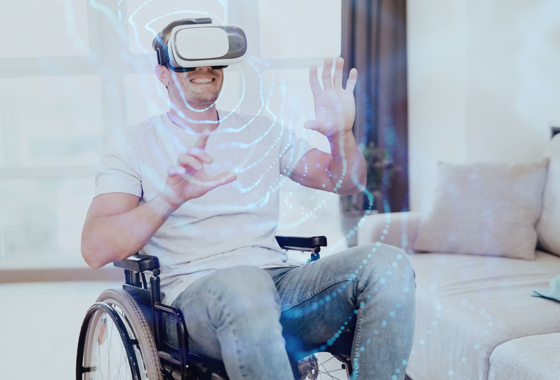 A man in a wheelchair wearing a VR headset performing hand gestures