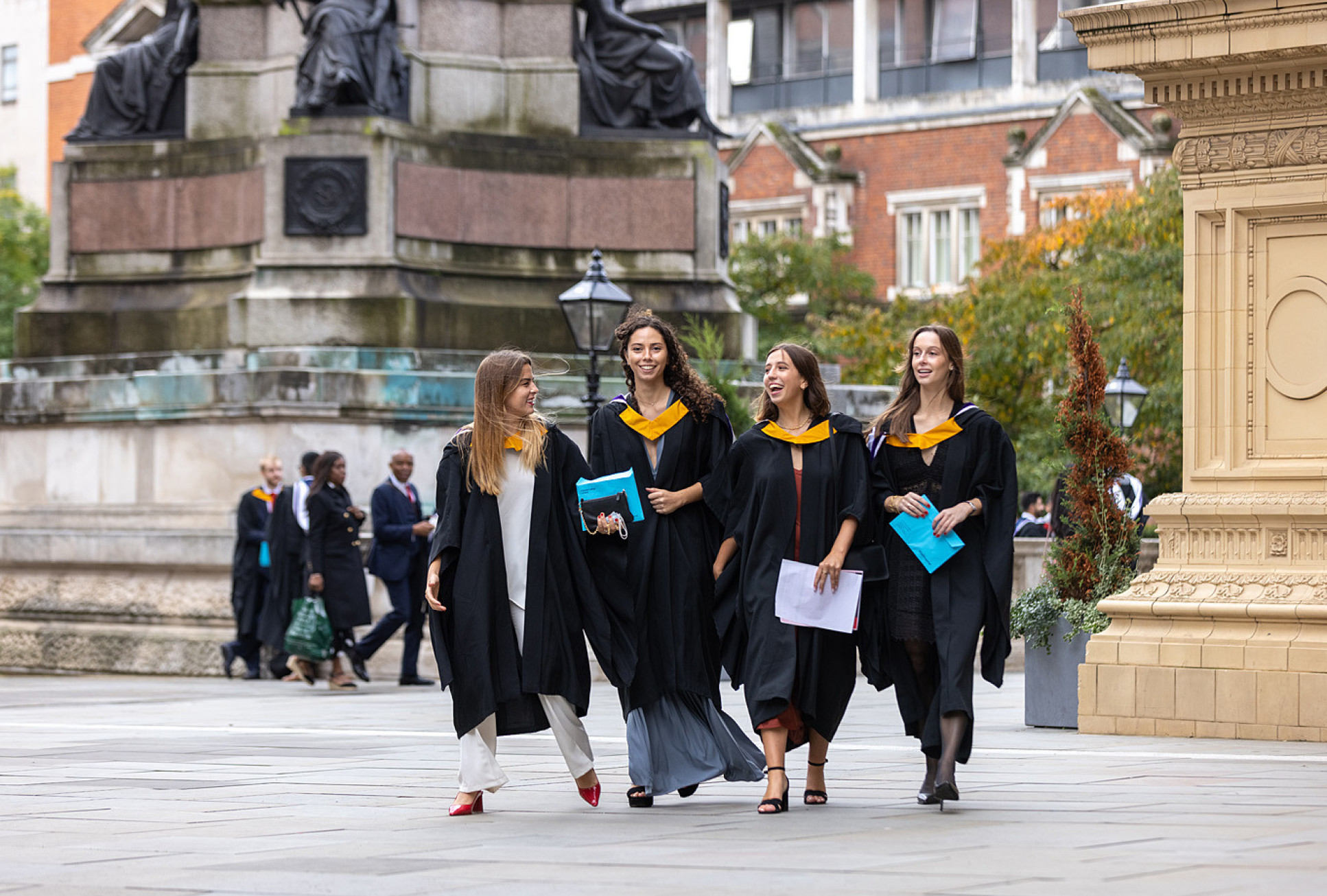 four women in graduation gowns