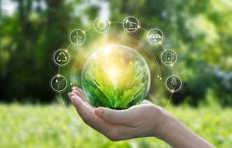 A hand holding a plant, with icons surrounding it to represent sustainability