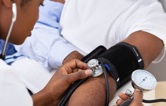 A doctor taking a patient's blood pressure