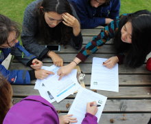 six students work together over a desk