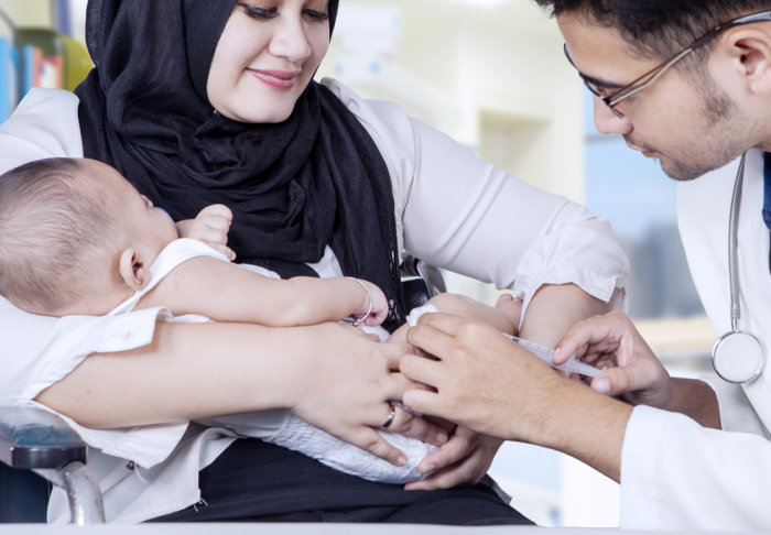 A baby boy receiving a vaccination