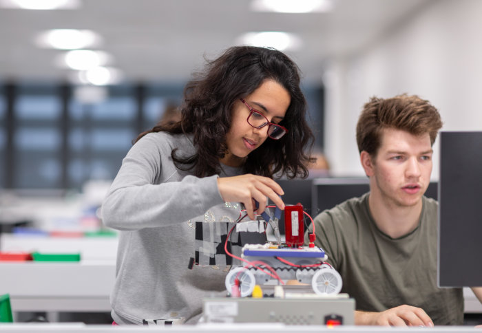 Students in the Mechatronics lab with the robot