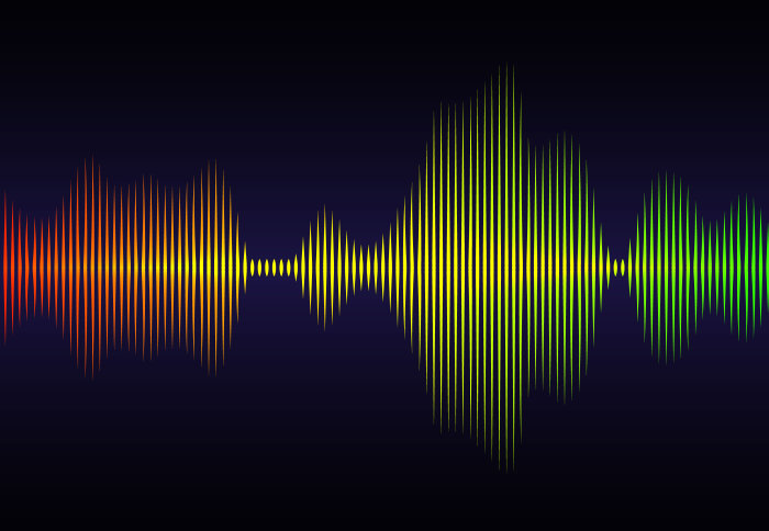 An illustration of a sound wave, colourful lines against a black background