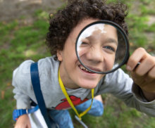 A child with a magnifying glass