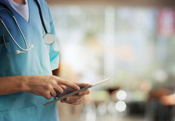 A doctor using a tablet computer