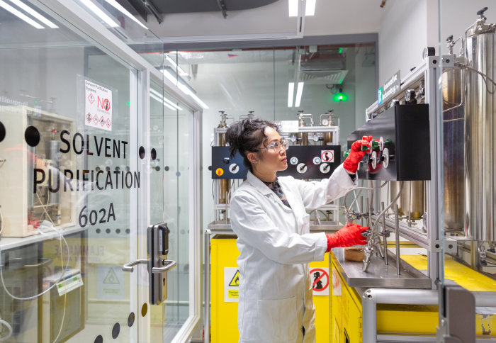 Female lab technician working in a chemistry lab.