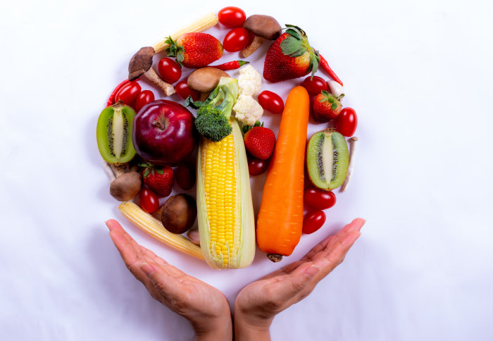 A hand holding food in the shape of a globe