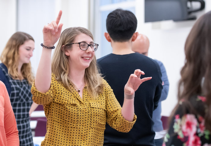 Dr Rebecca Bell gesturing to illustrate tectonic movement