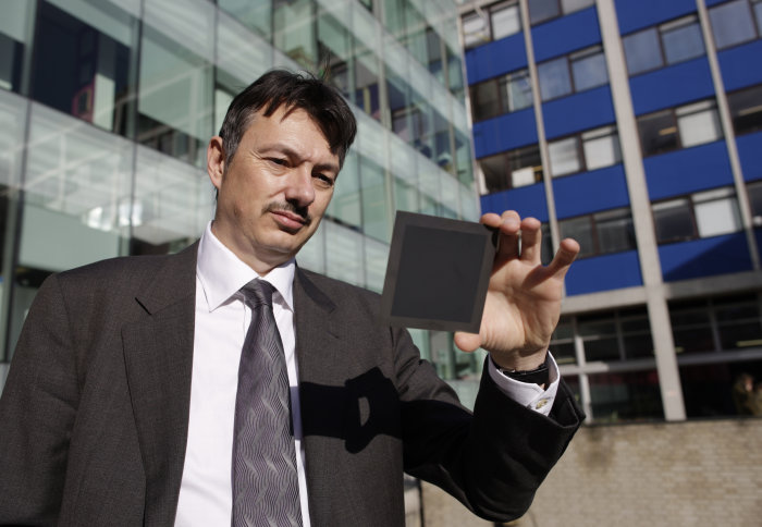 Professor Nigel Brandon is pictured holding a prototype Ceres fuel cell component