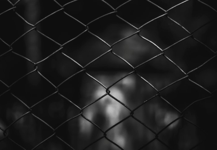 A person behind a fence