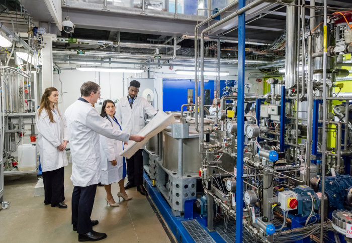 Home Secretary Priti Patel MP with Dr Colin Hale and students in the Carbon Capture Pilot Plant