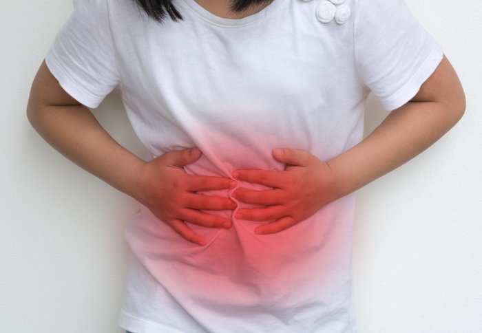 Woman Child's hands on her stomach with red spot as suffering on stomachache