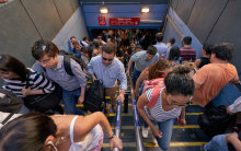 Photo of people walking up some stairs to catch a train