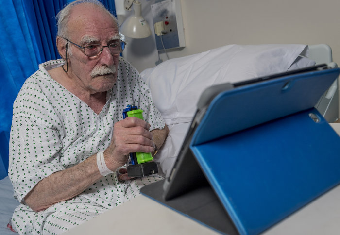 Patient using tablet in a hospital setting
