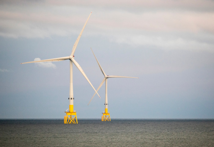 Two large wind turbines in the sea