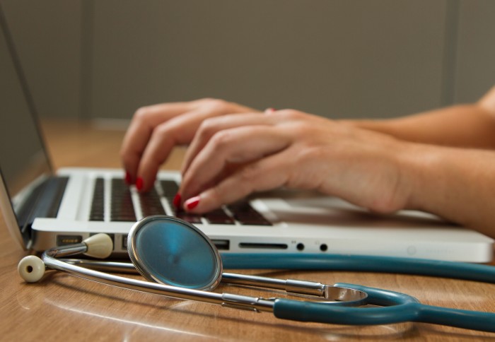 Person typing at a laptop