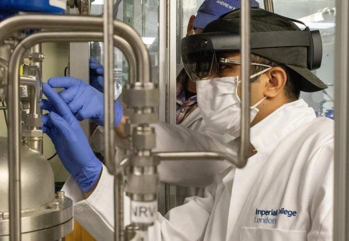 Two men in a lab wearing masks