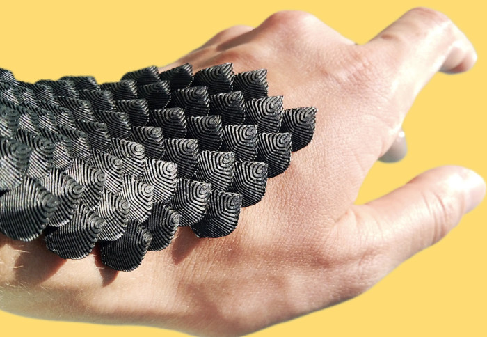 A hand wearing SCALED's flexible and protective wearable device