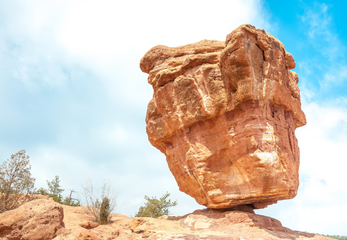 A huge rock balanced precariously in the Garden of the Gods in Colorado Springs, Colorado. It looks like it will topple over at any minute.