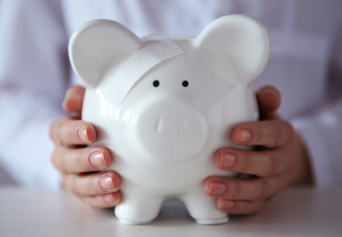 Piggy bank being held by a person