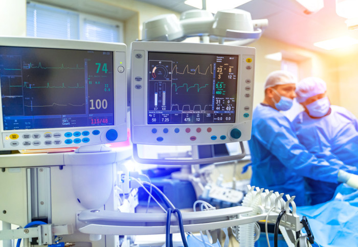 A monitor showing patient vital signs in a hospital intensive care unit