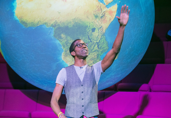 Chris Jackson talking in front of a giant globe