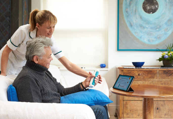 A patient using GripAble's digitally-enabled handheld device for upper limb rehabilitation