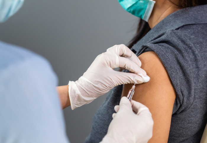 A person receiving a vaccination in the arm
