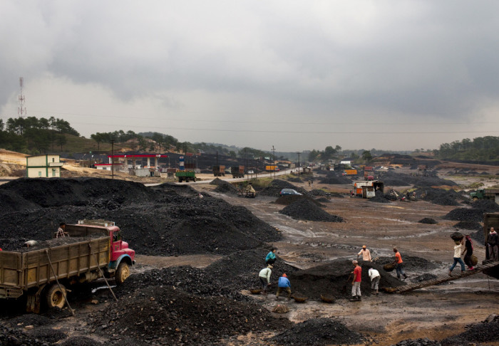 Piles of coal with workers