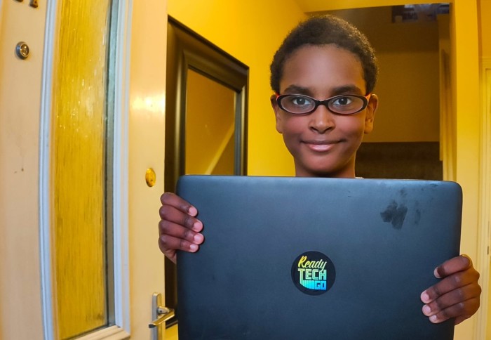 A recipient of a donated laptop