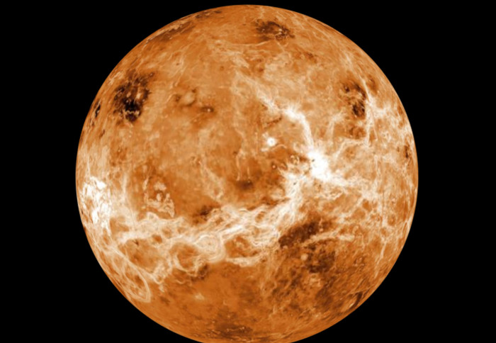 The northern hemisphere is displayed in this global view of the surface of Venus. It is a fiery orange colour.