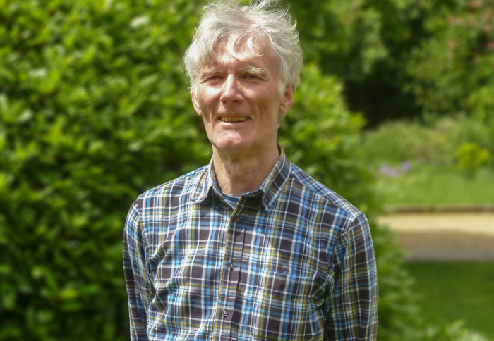 Image of Dr Damian Cummins standing in a garden