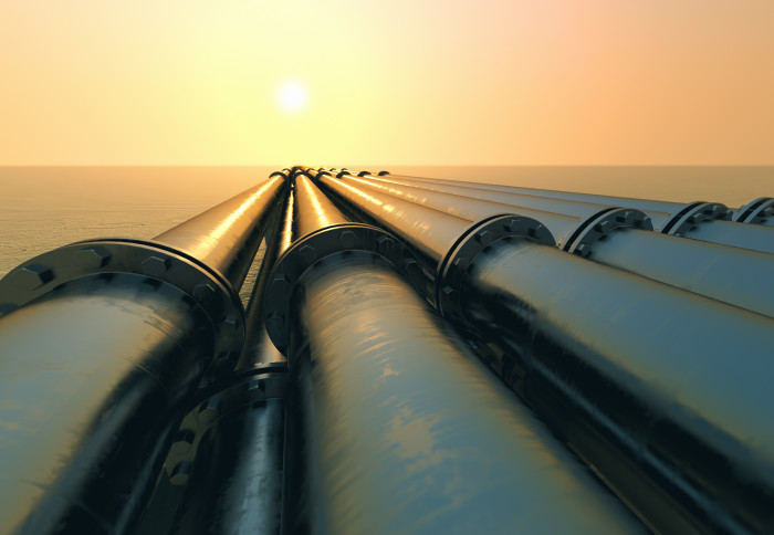 Tubes running in the direction of the setting sun. Pipeline transportation is most common way of transporting goods such as Oil, natural gas or water on long distances.