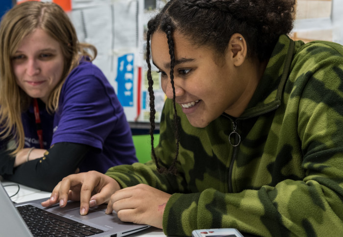 Two women looking at a laptop