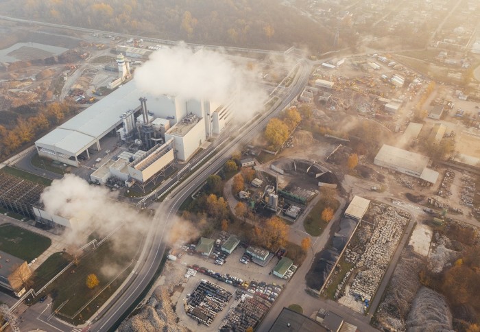 Bird's eye view of industrial buildings producing smoke