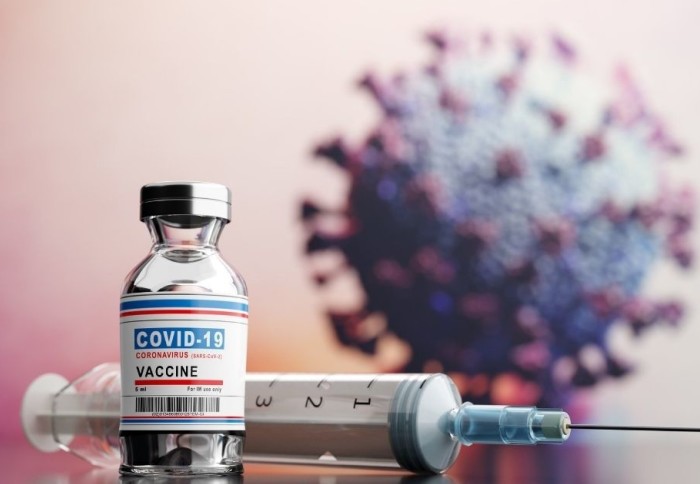 COVID-19 vaccine with virus in background