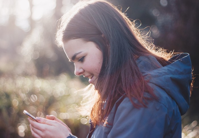 Young girl looking at a mobile phone