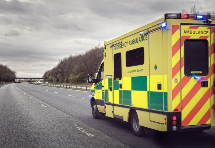 Photo from behind of ambulance driving down motorway