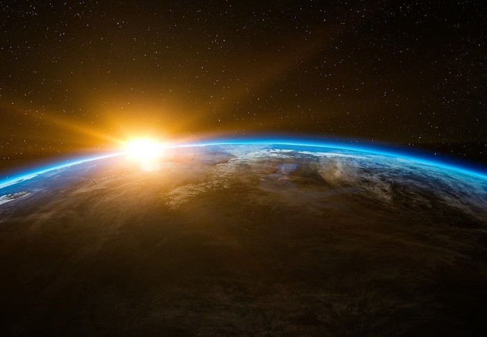An image of the earth with the sun shining