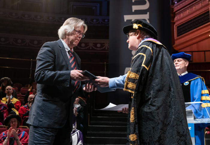 Rod Evans, husband of Professor Dame Georgina Mace, accepts the honorary award.