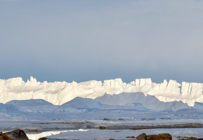 Antarctic coastline with snowy mountains behind