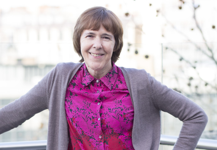 Professor Anne Dell stands on a balcony