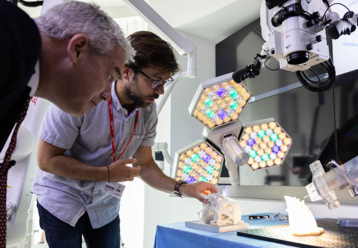 Two people looking at microscope