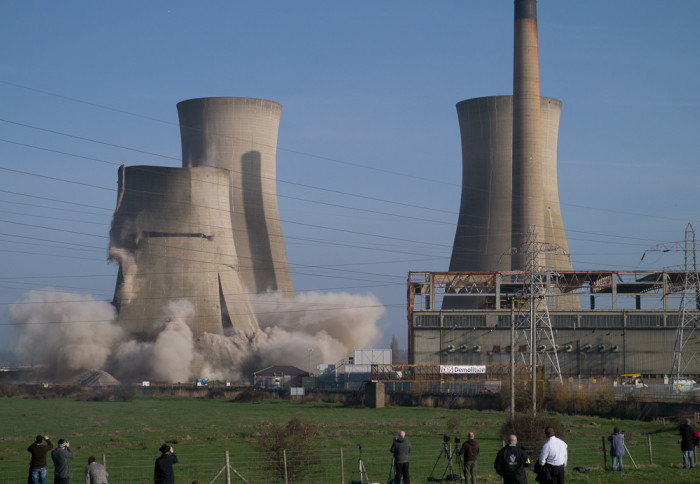 A water tower from a coal-fired power plant is demolished