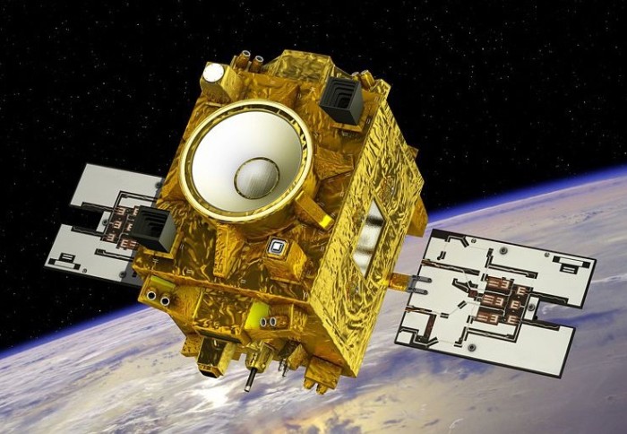 Artist's impression of a gold cubed-shaped satellite with side panels above the Earth