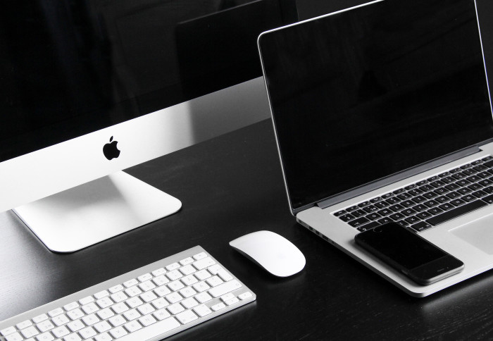 Image of Apple desktop computer, laptop and iPhone.