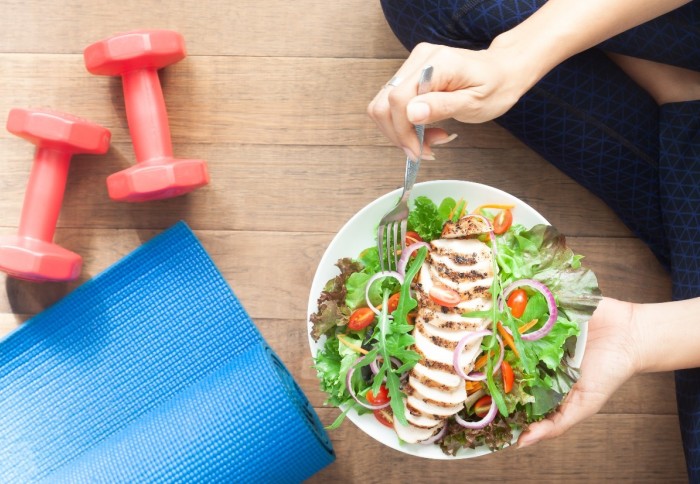 Image of exercise equipment and a healthy salad