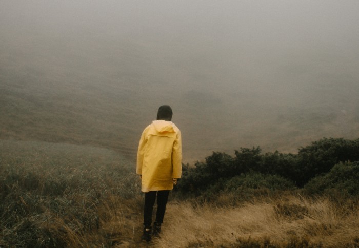 Person walking in misty hills
